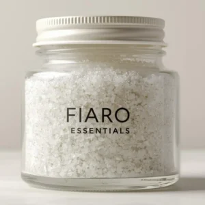 Clear jar of Fiaro Essentials bath salts with silver lid.