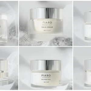 Luxurious skincare jar with a sleek silver lid on a white surface.